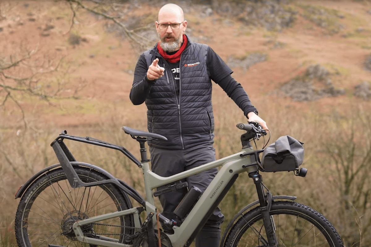 Dan giving a thumbs up with a Riese & Muller e-bike in the background